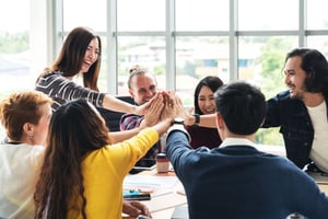 team of employees high-fiving