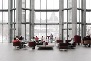 people chatting in a lobby on couches