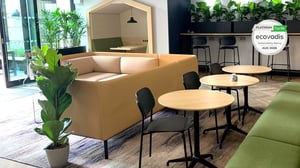 Lounge seating and cafe tables in an office furnished by JPA Workspaces, with the EcoVadis Platinum Top 1% badge